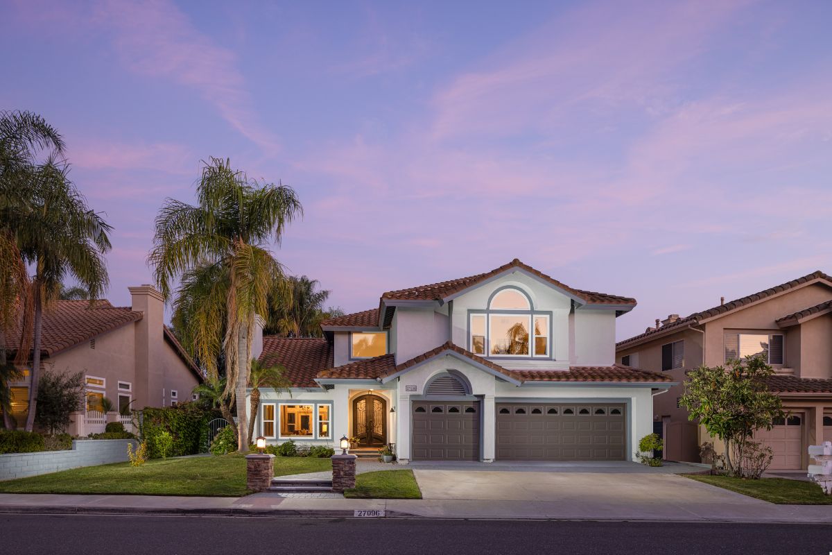 A home with palm trees and a driveway at dusk at 27096 Ironwood Dr