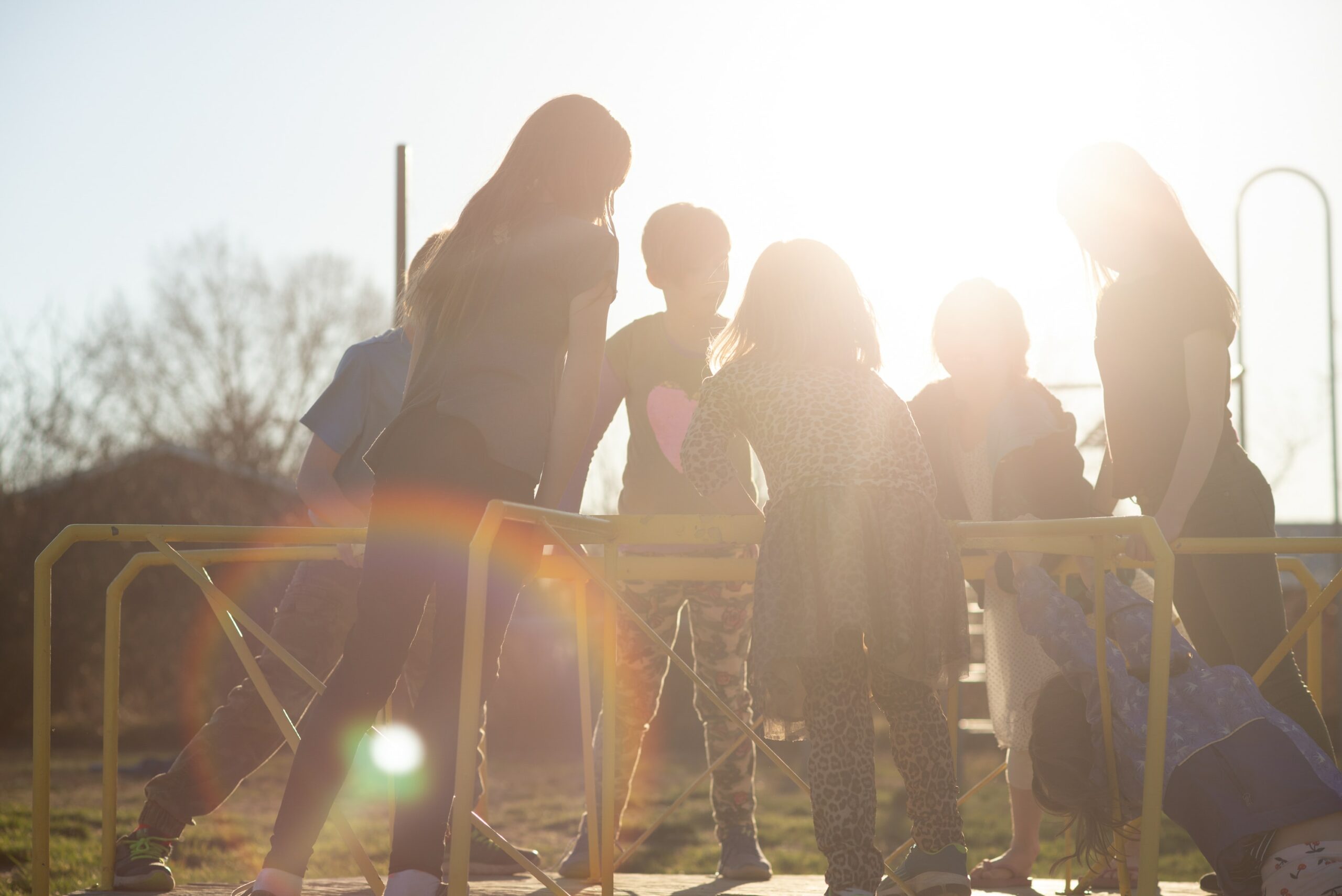 Silhouette of kids standing at the playground