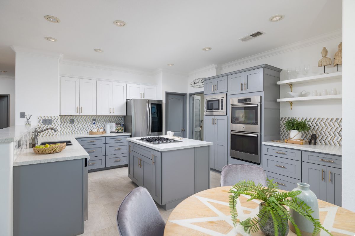 Luxury Kitchen in home in Moulton Ranch Featuring Light Blue Cabinetry, Stainless Appliances and an Island