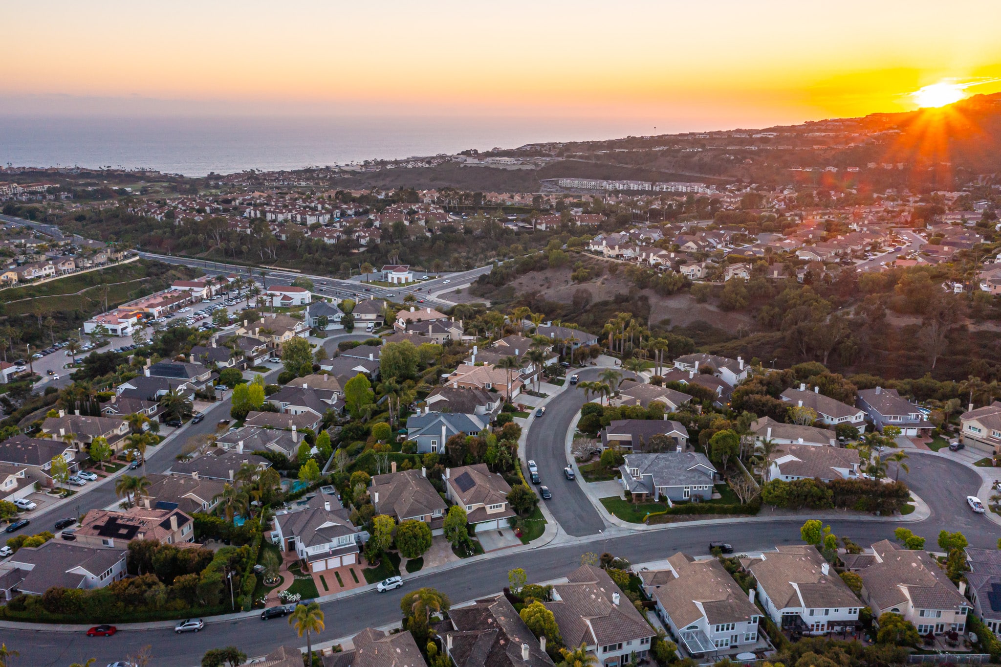 An aerial view of a picturesque Orange County neighborhood with a number of renovated homes.