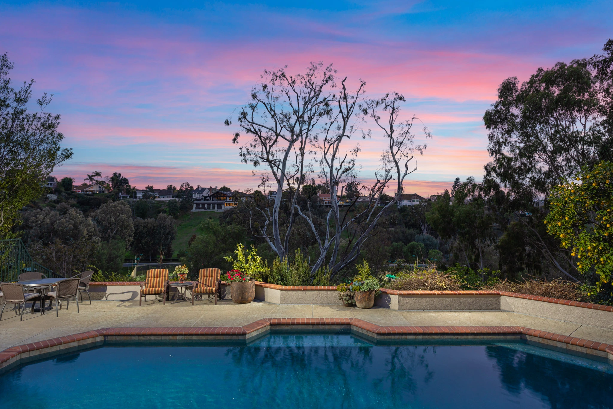 Backyard pool at sunset in an Orange County home, reflecting the tranquility and potential of the 2024 real estate market.