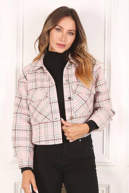 Woman with Light Brunette Wavy Hair Wearing a Pink Plaid Crop Jacket, Black Turtleneck, and Black Jeans from Olivia’s Closet Boutique