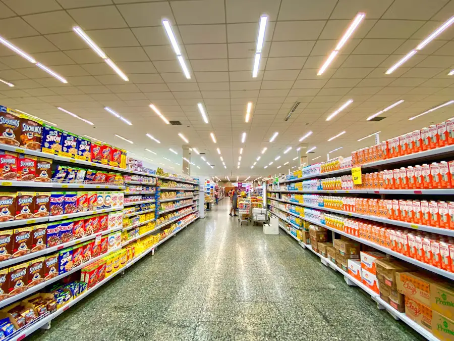 Grocery Store Aisle with Cereals, Drinks, and Clerk Stocking Shelves