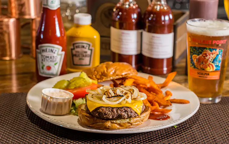 Burger with Cheese, Onions, Heinz Ketchup and Mustard, and a Side of Sweet Potato Fries and Tall Glass of Beer at Trabuco Oaks Steakhouse