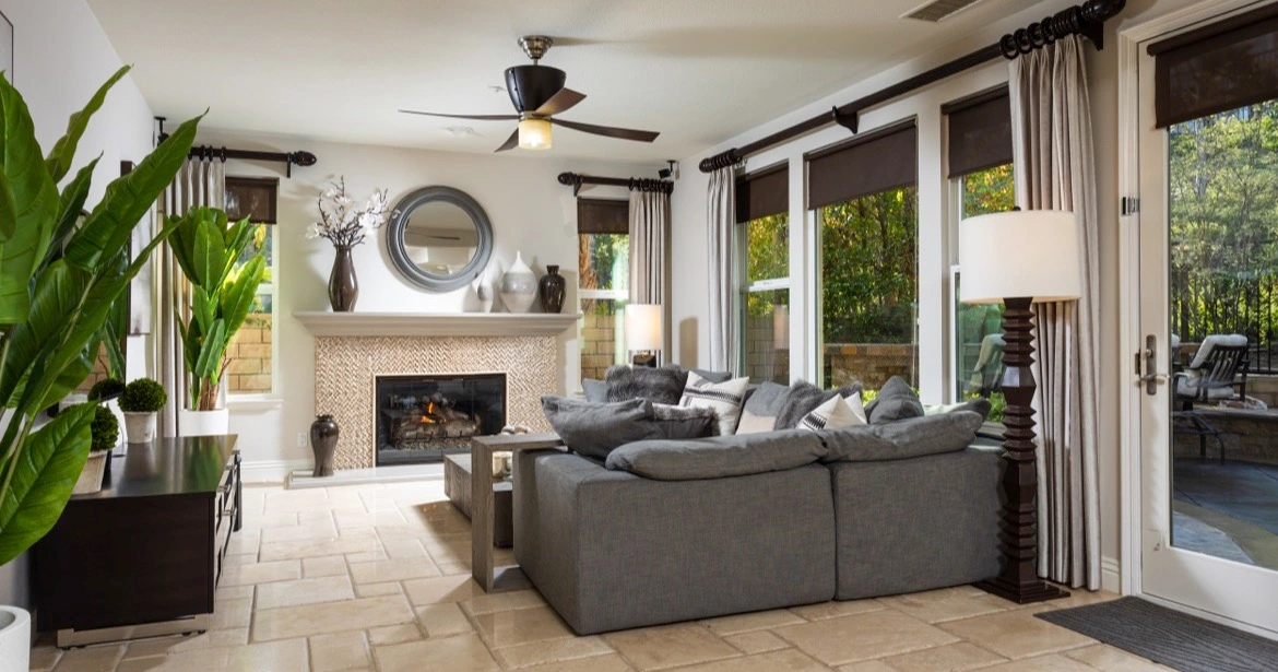 Stylish Laguna Niguel living room with fireplace and light tile floors, offering seamless indoor-outdoor living in Orange County real estate.