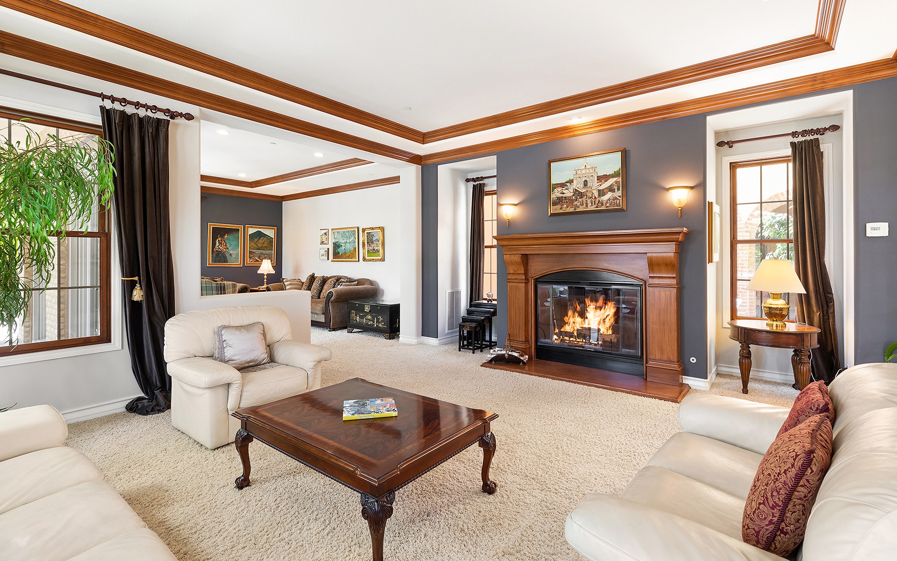 Traditional living room with cozy carpeting and fireplace