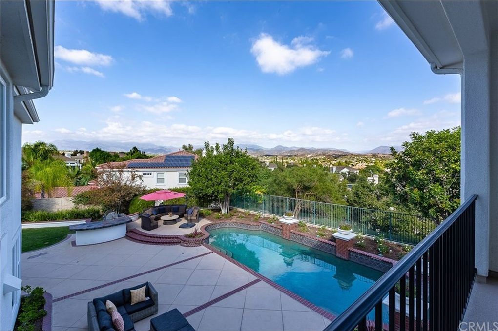 Backyard of a Coto de Caza property featuring a pool and stunning community views