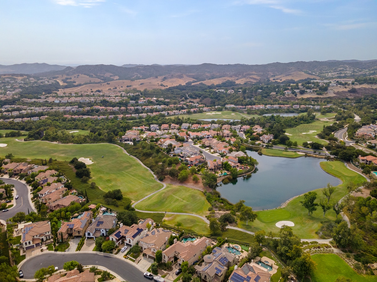 Aerial view of Coto de Caza showcasing luxury homes, golf course, and scenic pond