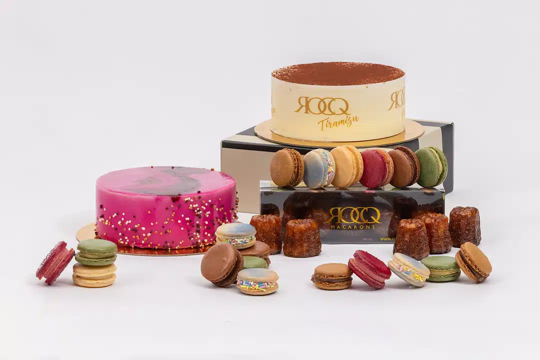 Beautiful and Colorful Display of Assorted Macarons, Canellis, and Cakes including Tiramisu Cake from Rocq Macarons