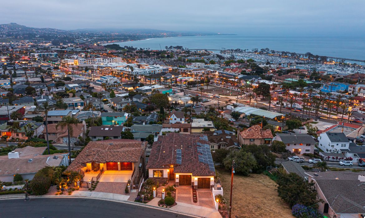 Aerial view of a luxury home in Dana Point with ocean views at dusk