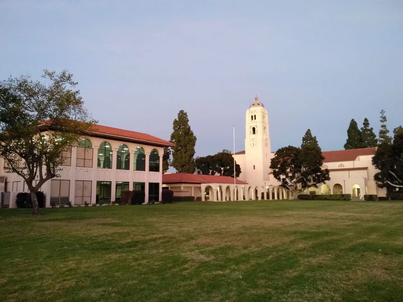 Clock Tower in Mission architectural style with trees and walking path in the foreground at Fullerton Union High School