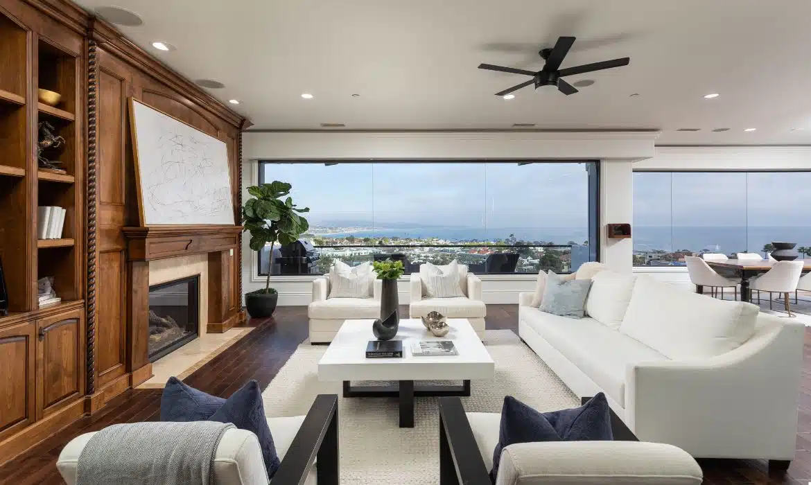 Bright living room with floor-to-ceiling windows showcasing Lantern District views in Dana Point luxury home