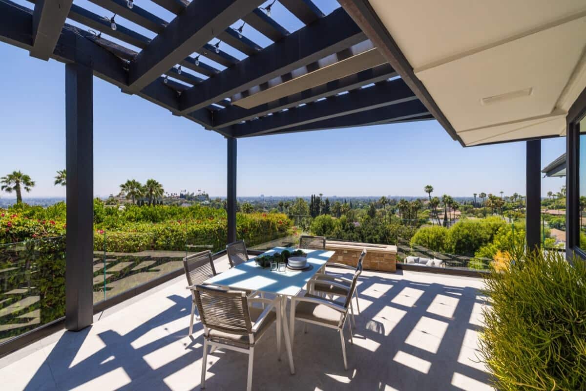 outdoor dining area with trellis and fire pit, with more huge views of Tustin, from 11821 Highview Dr, luxury home for sale by Brad Feldman Group top realtors