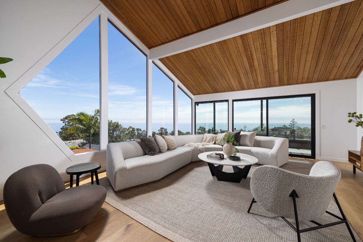 Interior living room of Laguna Beach luxury modern home with huge windows looking out to ocean views, sold by best agents Brad Feldman Group