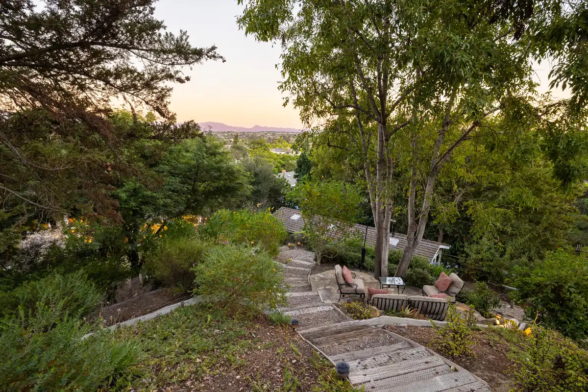 View through trees of hills from the backyard of a Laguna Hills home sold by Bradley Feldman top Realtor agents in Orange County