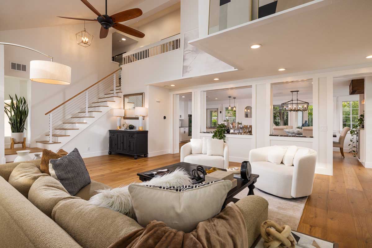 Home interior living room with spacious living area and two story ceiling in luxury property sold by top real estate agents in Laguna Niguel