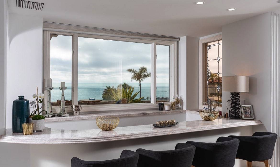 Breakfast bar with ocean views inside the Dana Point luxury home showcasing the best time to sell a home in the area