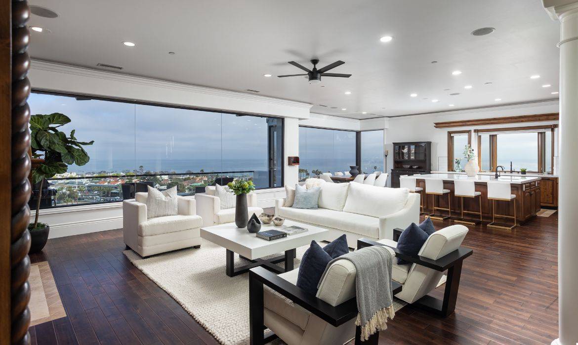 Dana Point luxury home living room with huge wall of windows overlooking the ocean, sold by top listing agents