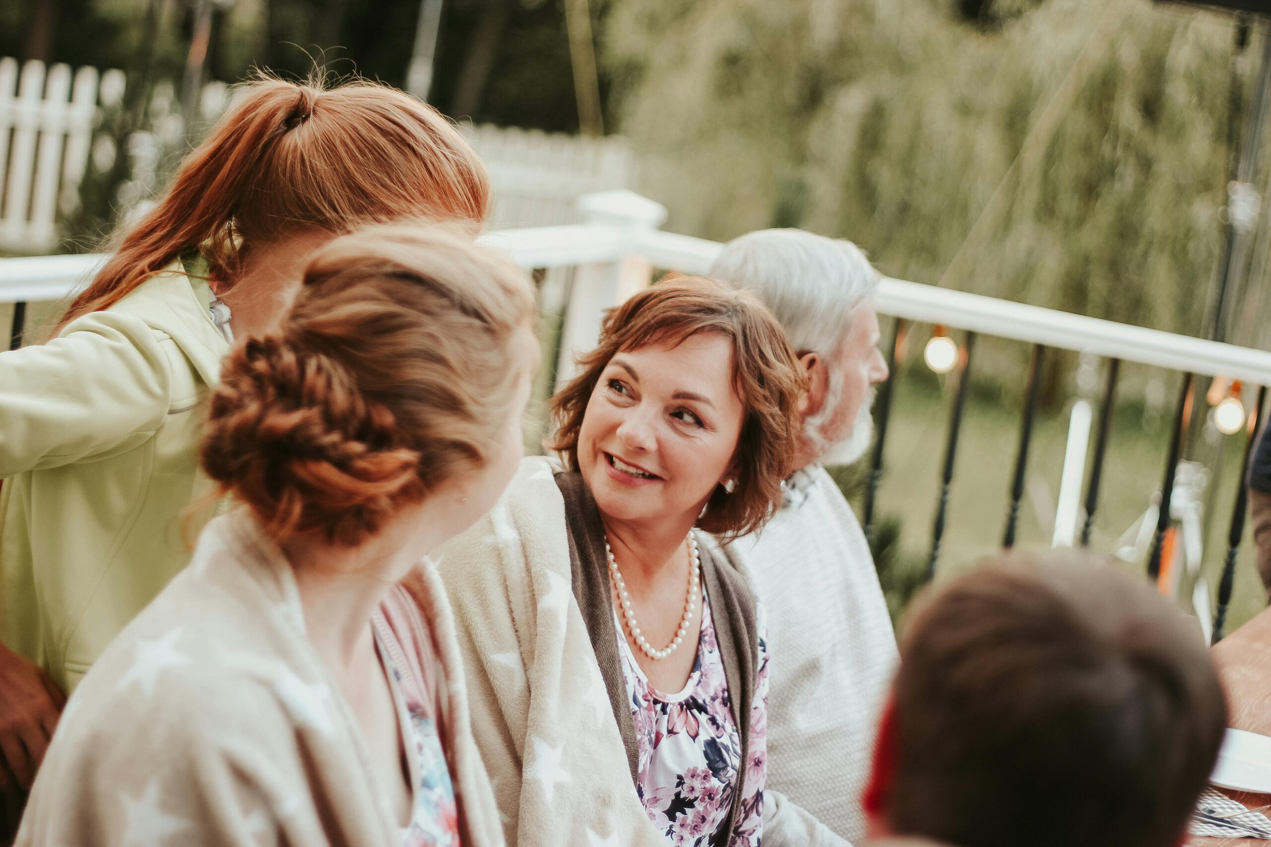 Grandparents with younger family in the backyard of their Laguna Hills house selling to buy a smaller home with top local Realtor agents