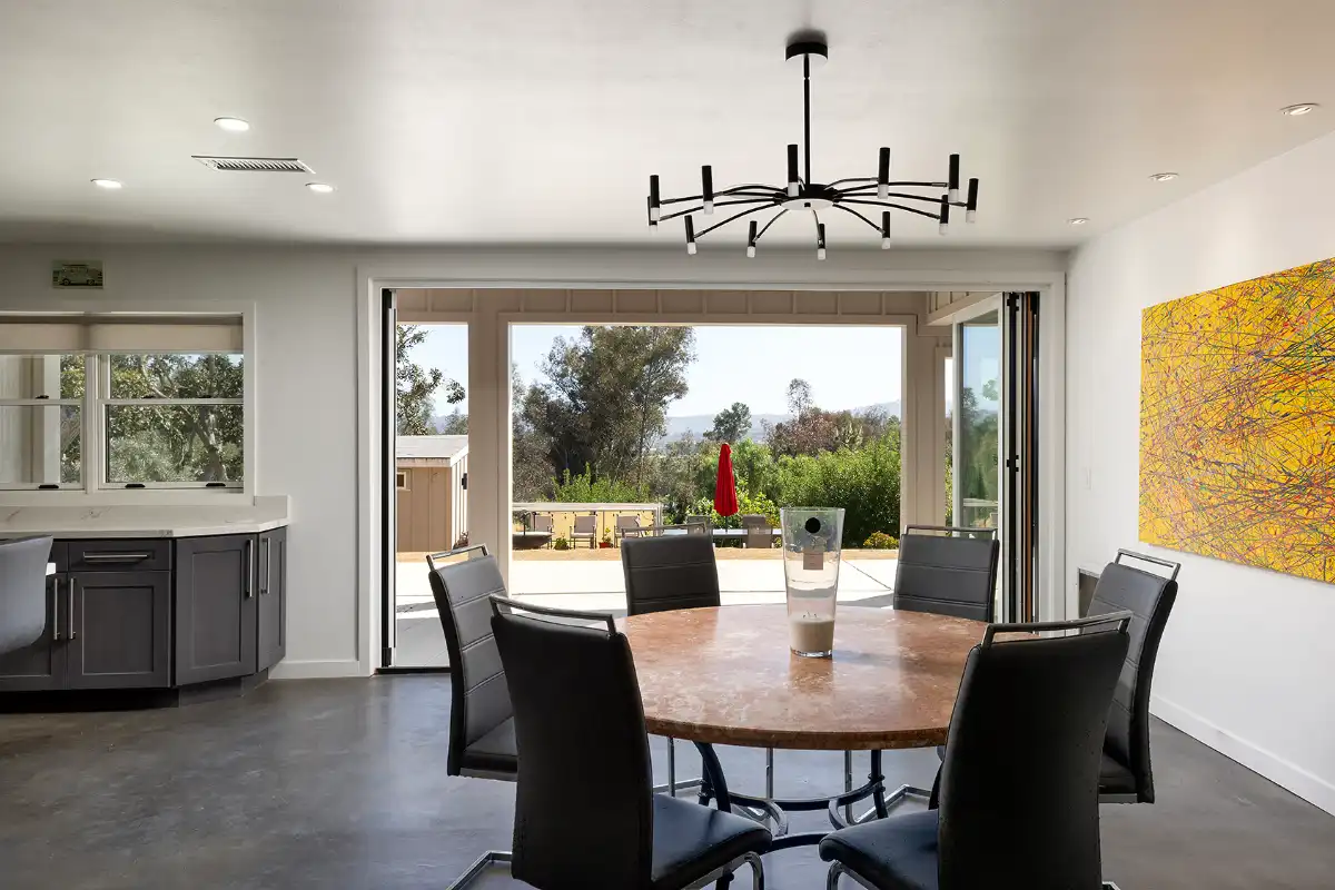 Dining room with view of outdoor living area in a luxury home prepped and sold by Brad Feldman Group