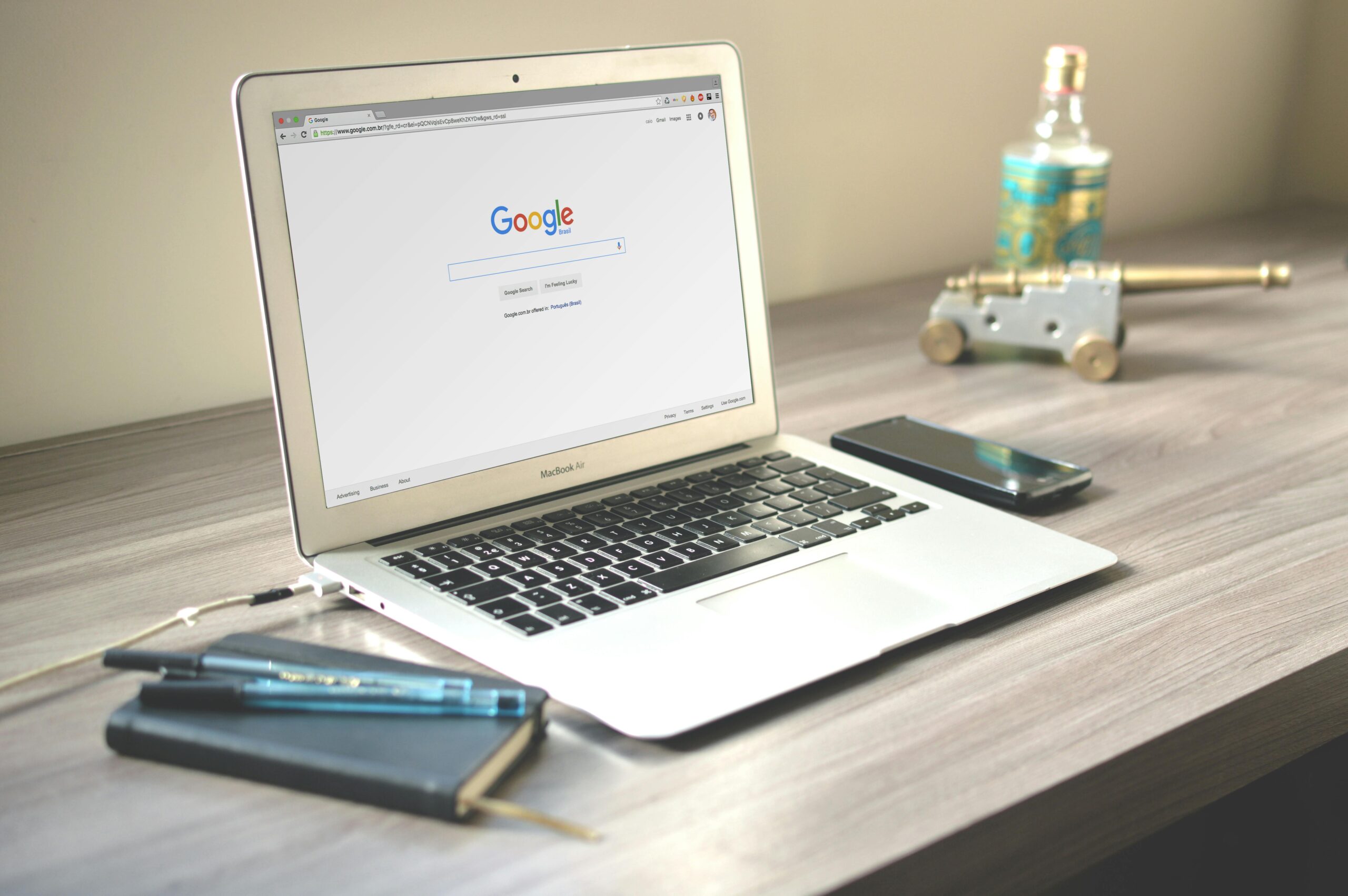 Macbook laptop on a grey table, with Google on the screen, depicting how to search and find the best Orange County realtors and real estate agent teams.