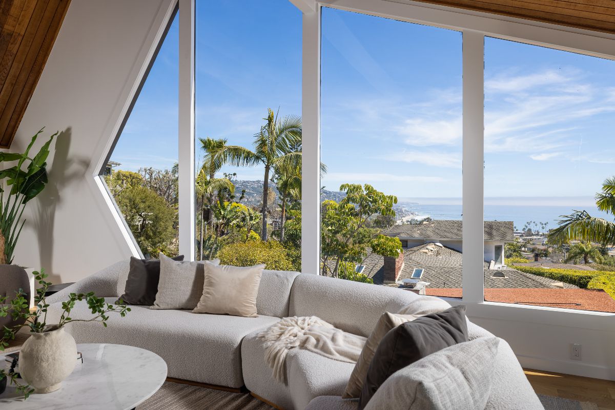 Window view above Laguna Beach with ocean waves and beach in the distance