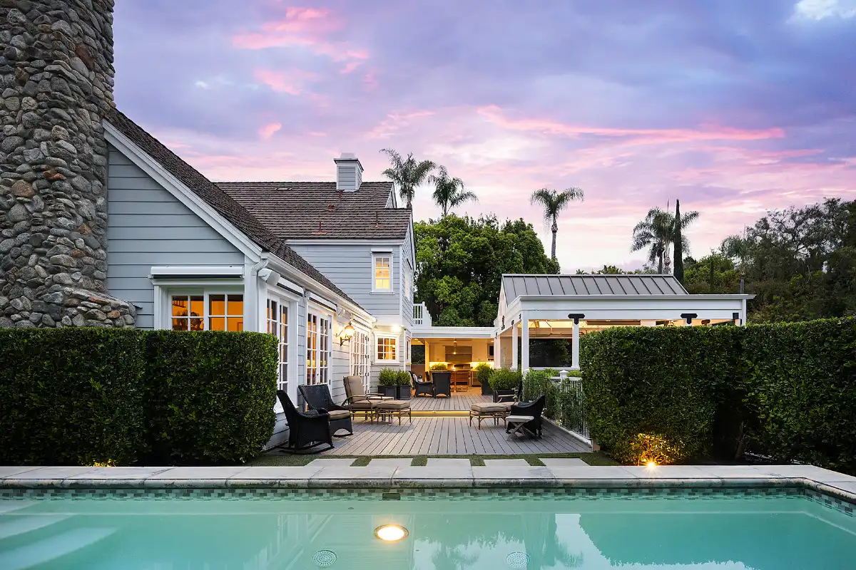 Outdoor living area with pool and patio chairs during the spring realtor best season to sell your home