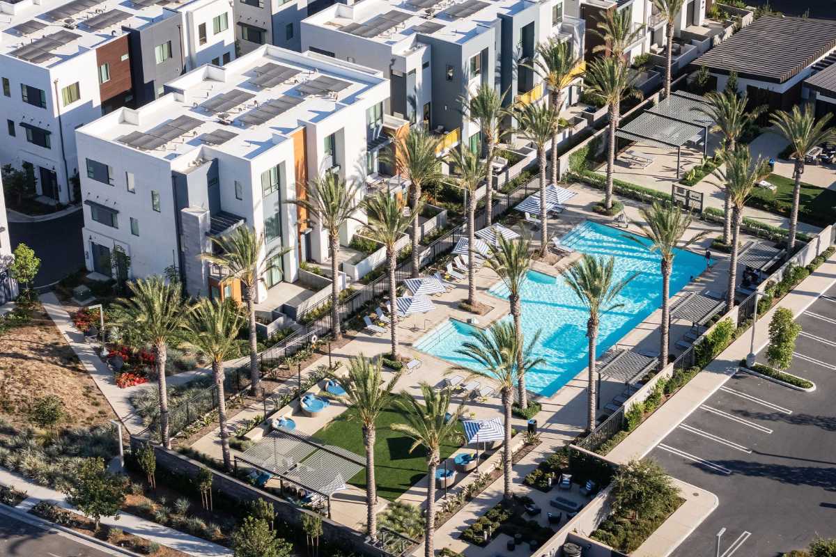 Luxury amenities with a pool and lounge area at an Orange County condo community, listed by top real estate agents Brad Feldman Group