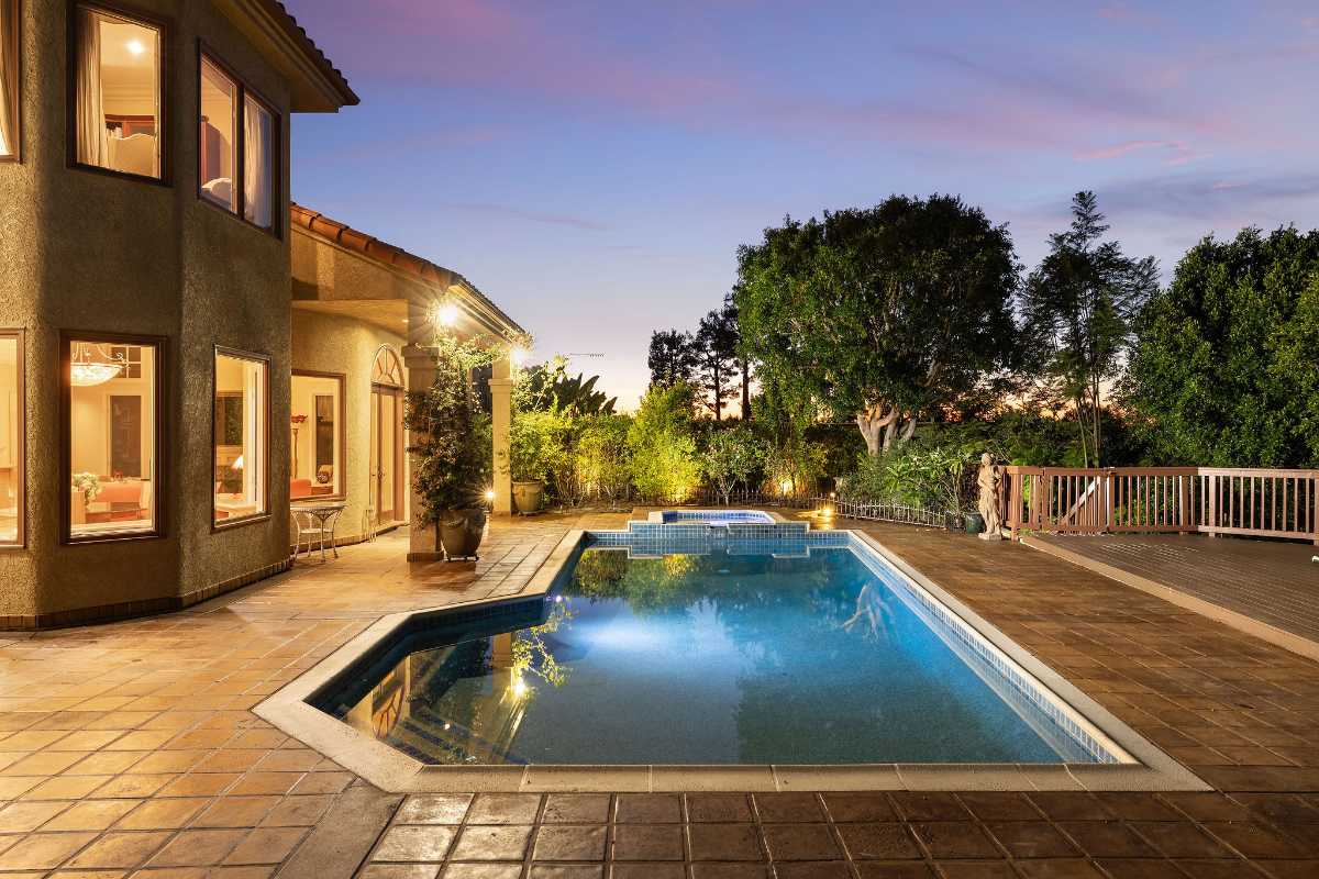 Backyard patio and pool of a luxury real estate listing home for sale by the best realtor agents for sellers in Orange County, Brad Feldman Group