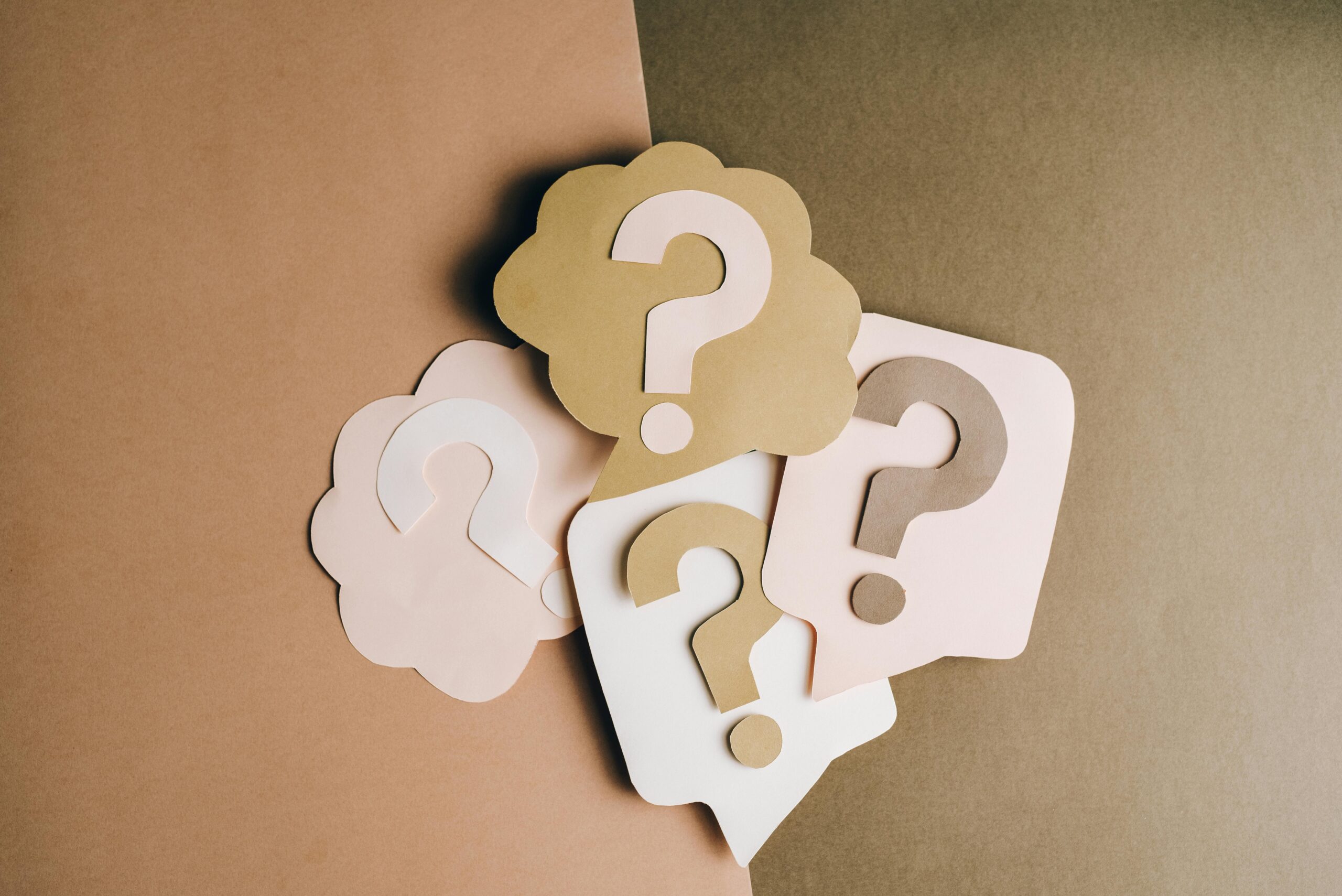 Question marks laid out in paper craft design, representing the top myths and misconceptions by property owners about selling your Orange County, CA home with the best local realtors and top real estate agents